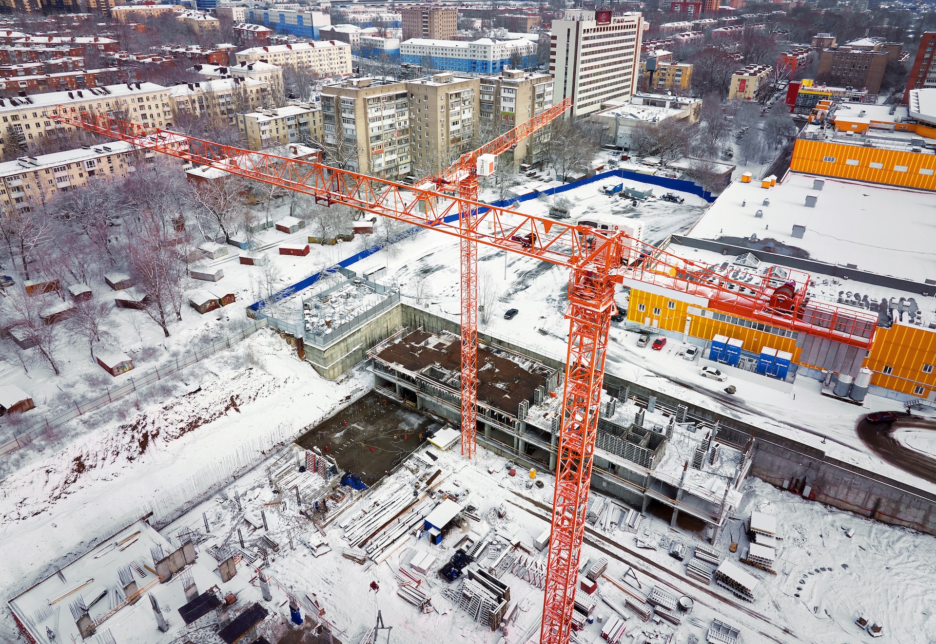 Construction Crane from Above. tower crane on the construction site aerial view. Aerial View Of construction site with crane. Construction workers are building. Top view